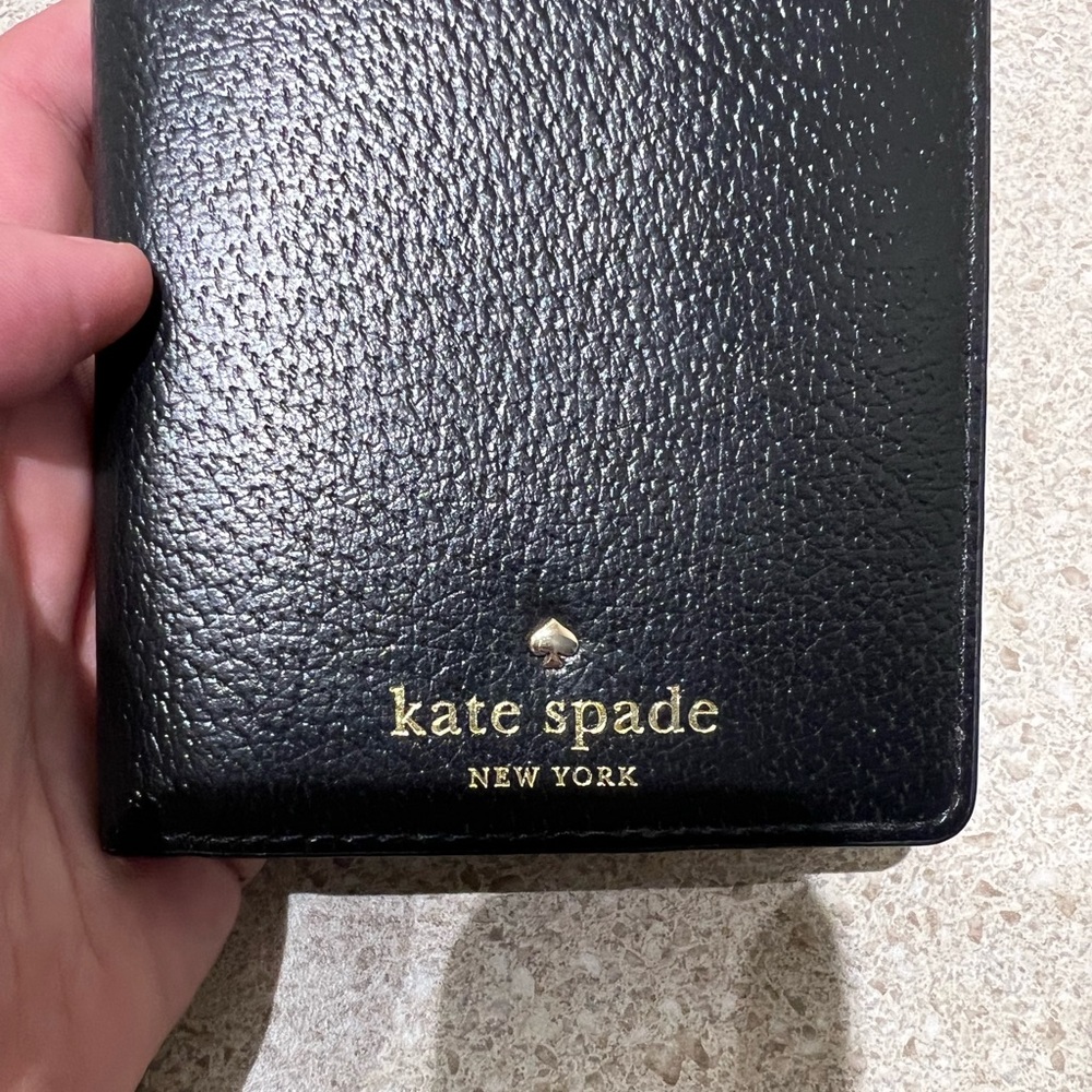 Like new Kate Spade passport holder in black.